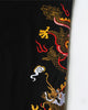 Close-up of the gold, red and white dragon embroidery on the leg