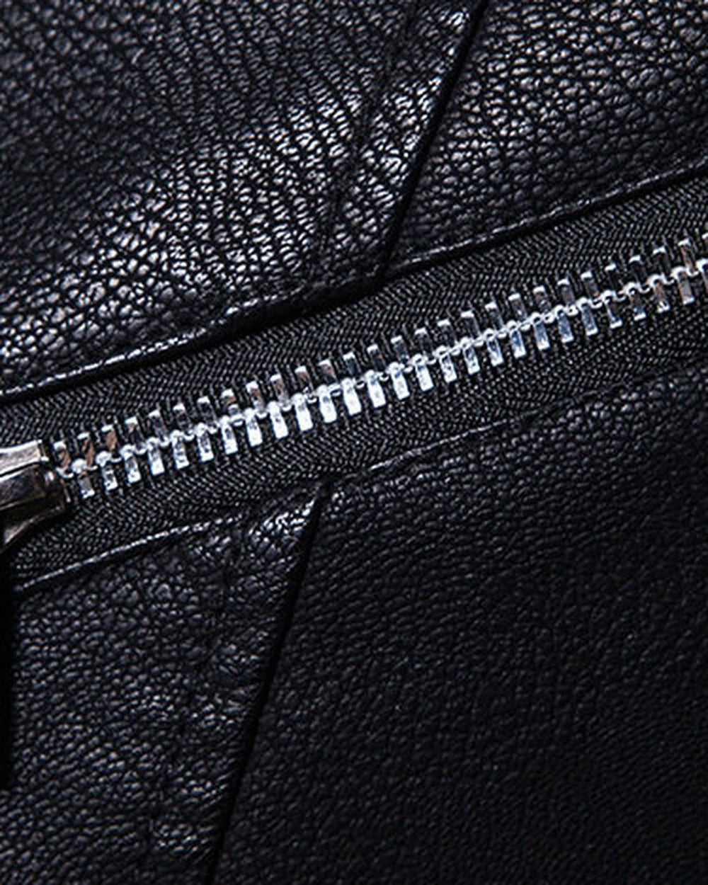 Close-up of the chest zip pocket and diagonal zip on the black biker jacket
