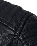 Close-up of the rib-quilted shoulder on the black biker jacket