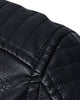 Close-up of the rib-quilted shoulder on the black biker jacket