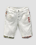 White denim shorts with three red embroidered icons on the thigh and jacquard-lined cuffs, front view