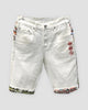 White denim shorts with three red embroidered icons on the thigh and jacquard-lined cuffs, front view