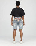 Model wearing the light blue washed denim shorts with a black tee, seen from behind, with the jacquard yoke
