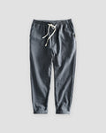 Dark gray striped cropped pants with a cream drawstring and turned-up cuffs, flat view