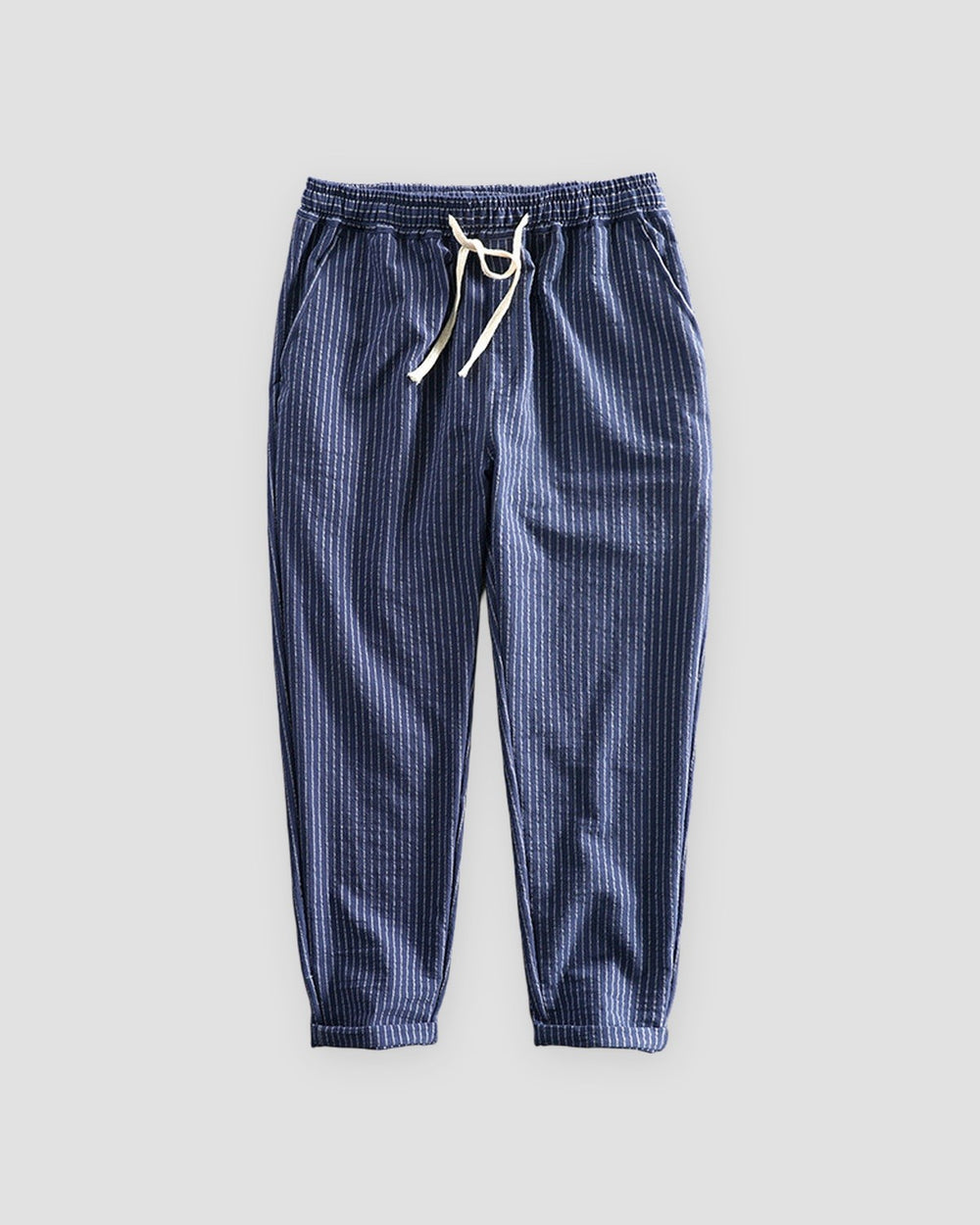 Royal blue striped cropped pants with a cream drawstring and turned-up cuffs, flat view