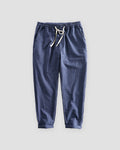 Royal blue striped cropped pants with a cream drawstring and turned-up cuffs, flat view