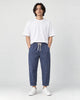 Model wearing the royal blue striped cropped pants with a white tee and off-white sneakers, front view
