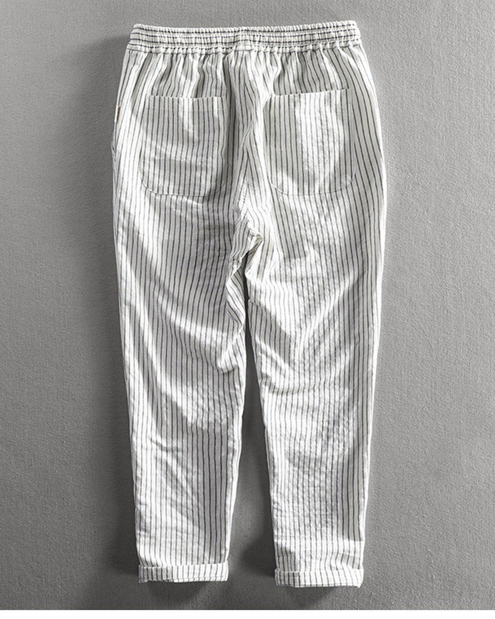 Back view of the white striped cropped pants showing the back patch pocket and the turned-up cuffs