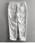 Back view of the white striped cropped pants showing the back patch pocket and the turned-up cuffs