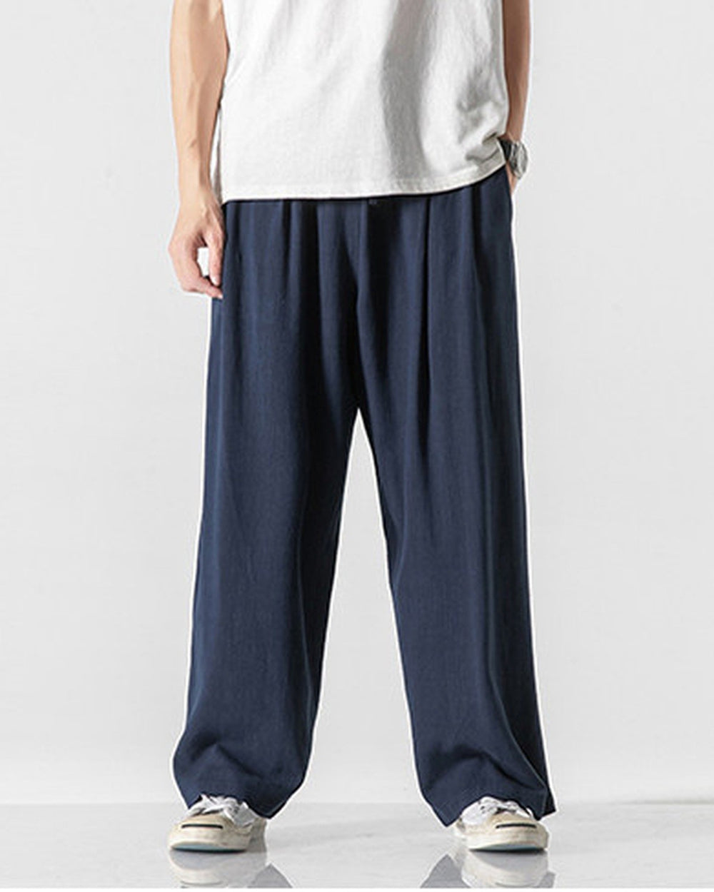 Navy wide-leg linen pants with an elastic waist, worn with a white tee and canvas sneakers