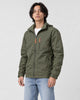 Model wearing the army green windbreaker jacket over a white tee with light-wash jeans, three-quarter crop