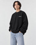 Model wearing the black chest print sweatshirt, three-quarter view
