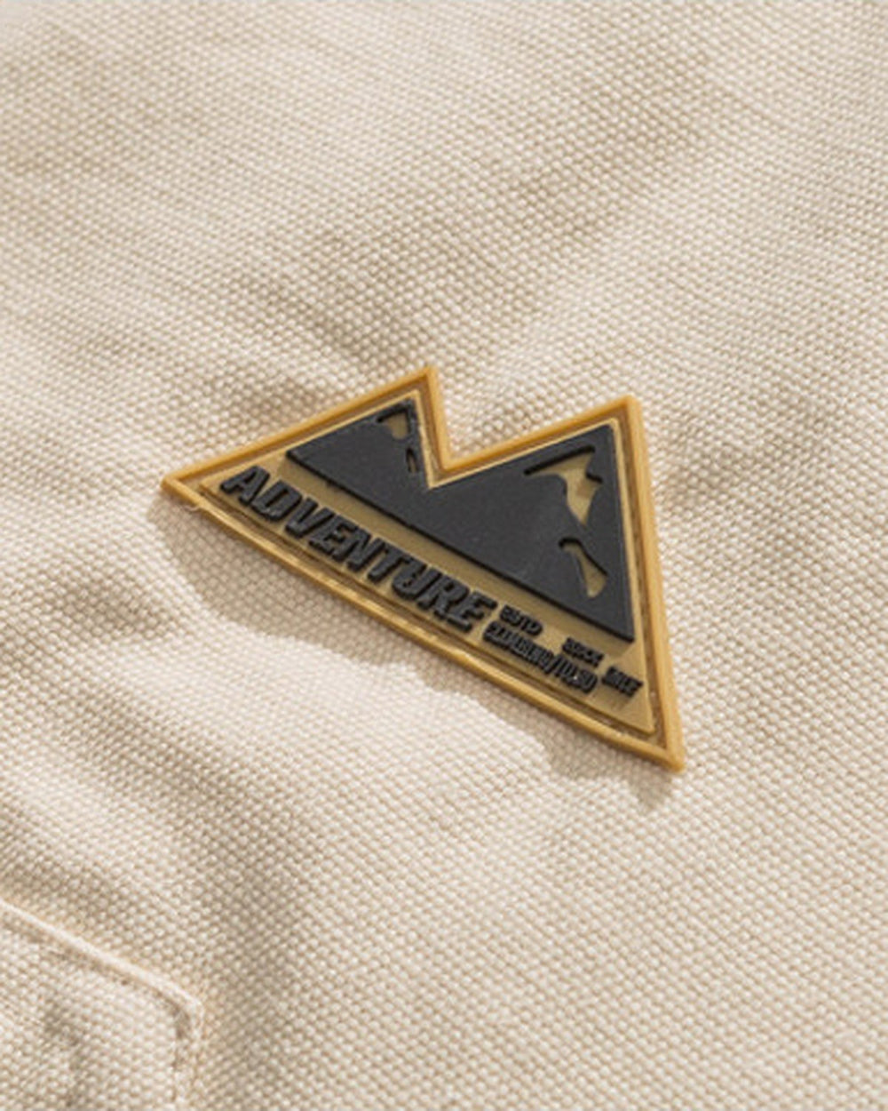 Close-up of the small triangular mountain badge on the chest