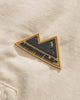Close-up of the small triangular mountain badge on the chest