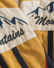 Close-up of the Mountains script and snowy peaks embroidered on the sleeve