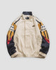 Beige color block jacket, front view, embroidered mountain sleeves in navy, mustard and red