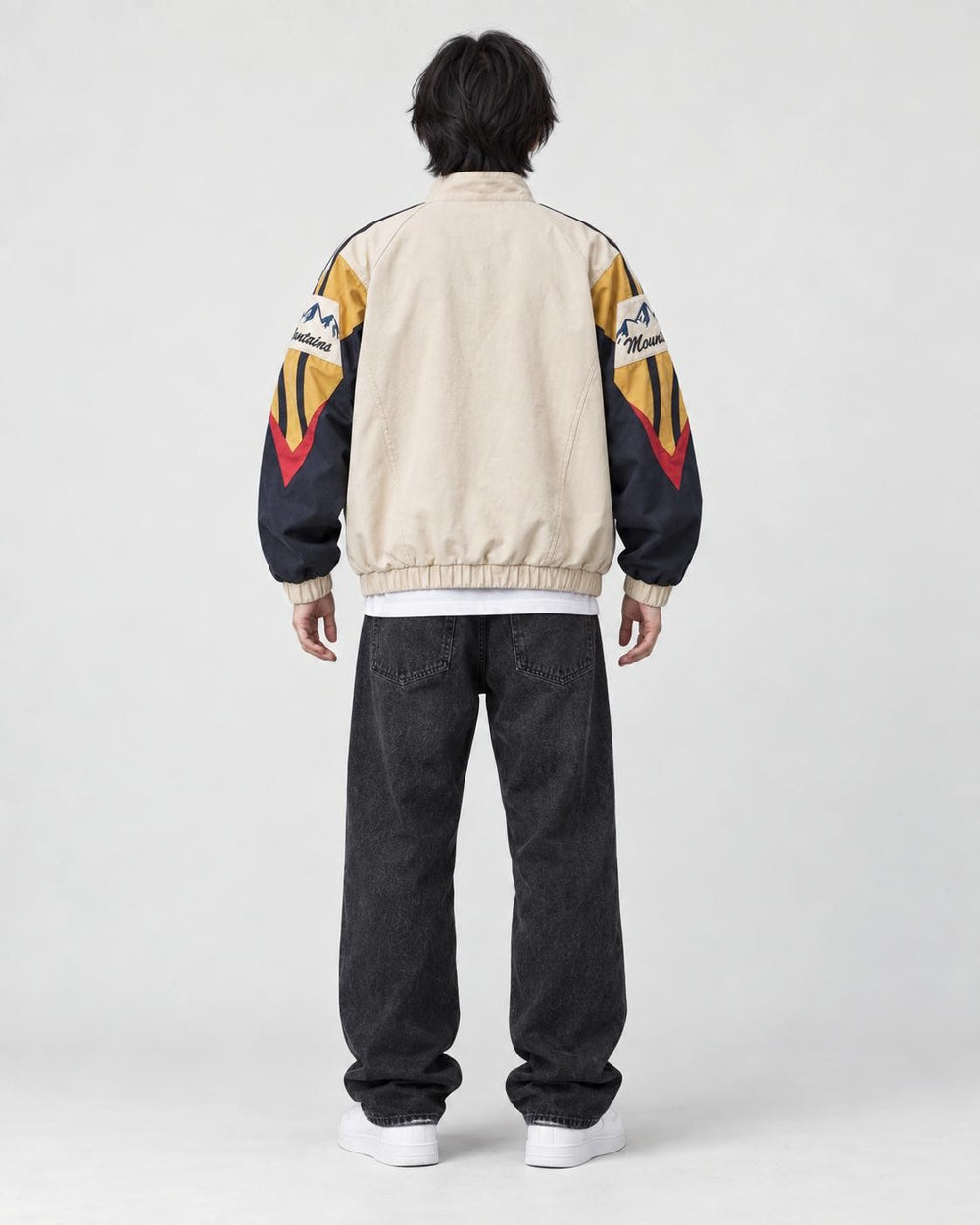 Model wearing the beige color block jacket, back view