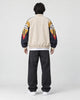 Model wearing the beige color block jacket, back view