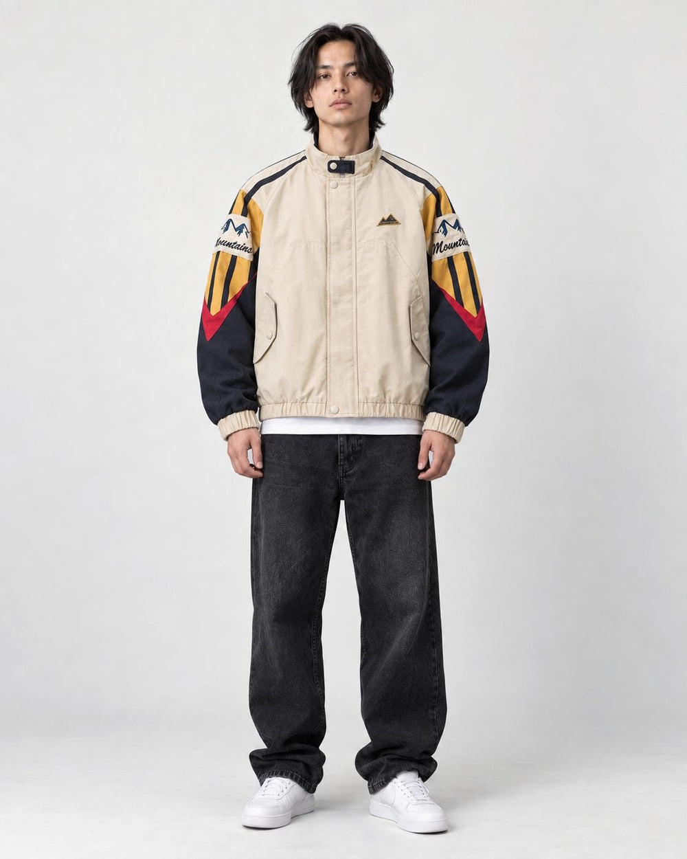 Model wearing the beige mountain color block jacket, front view