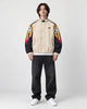 Model wearing the beige mountain color block jacket, front view