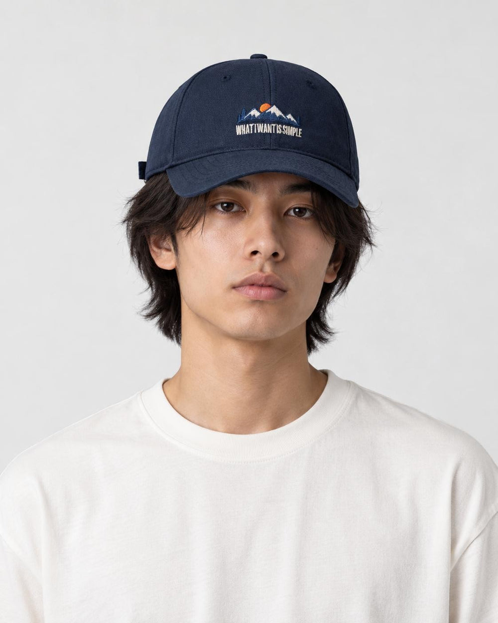 Model wearing the navy blue mountain sunrise cap, front view