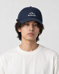 Model wearing the navy blue mountain sunrise cap, front view