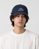Model wearing the navy blue mountain sunrise cap, front view