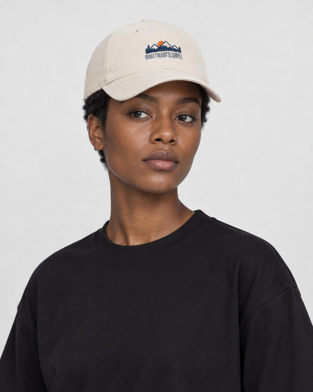 Model wearing the beige mountain sunrise baseball cap, three-quarter view