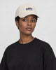 Model wearing the beige mountain sunrise baseball cap, three-quarter view