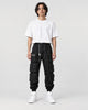 Model wearing the black multi-pocket techwear cargo pants, front view