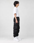Model wearing the black multi-pocket techwear cargo pants, side view of the stacked thigh pockets