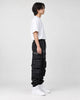 Model wearing the black multi-pocket techwear cargo pants, side view of the stacked thigh pockets