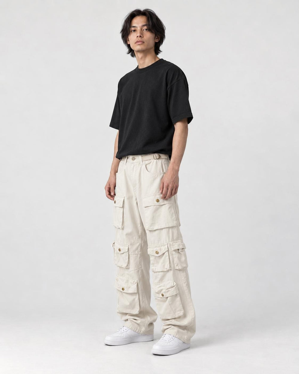 Model wearing the beige multi-pocket cargo pants, three-quarter view