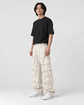 Model wearing the beige multi-pocket cargo pants, three-quarter view