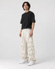 Model wearing the beige multi-pocket cargo pants, three-quarter view
