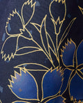 Close view of blue flowers with gold outlines on the dark navy haori