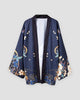 Dark navy haori jacket on a hanger, open front with a dark band and blue and cream flowers with gold lines at the hem