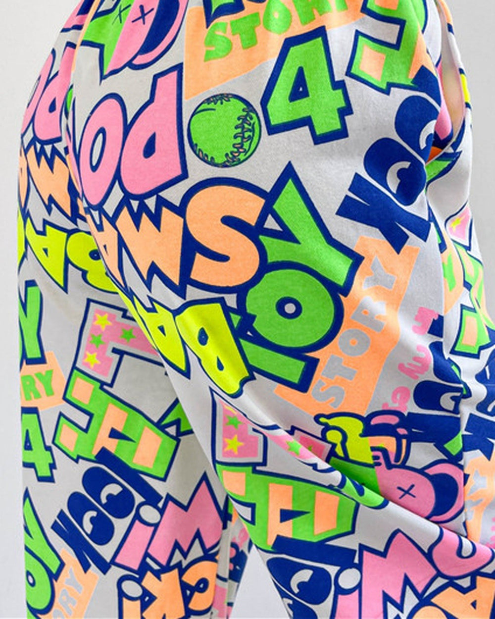Close-up of the neon TOY and WOW graffiti letters on the white ground