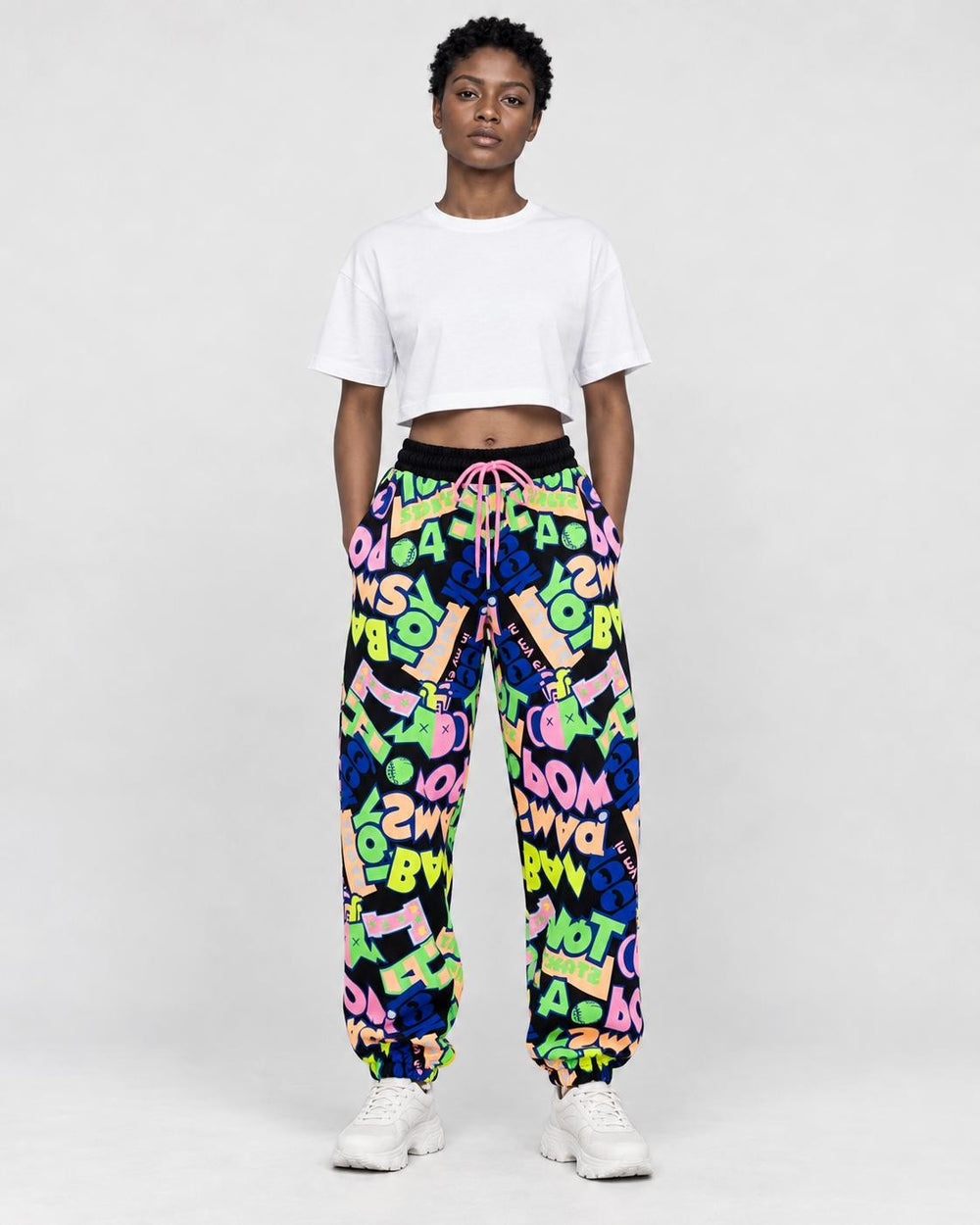 Model wearing the black-ground neon graffiti jogger pants, front view