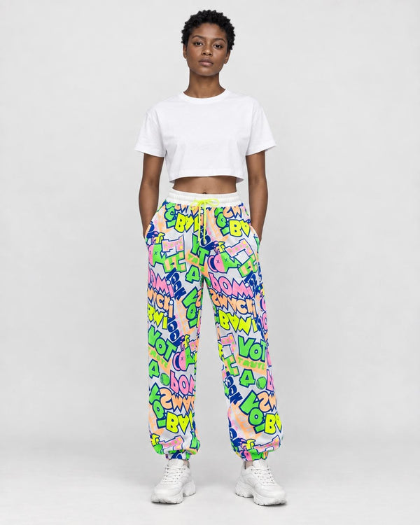 Model wearing the white-ground neon graffiti jogger pants with a cropped tee, front view