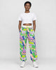 Model wearing the white-ground neon graffiti jogger pants with a cropped tee, front view