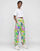 Model wearing the white-ground graffiti pants, three-quarter view