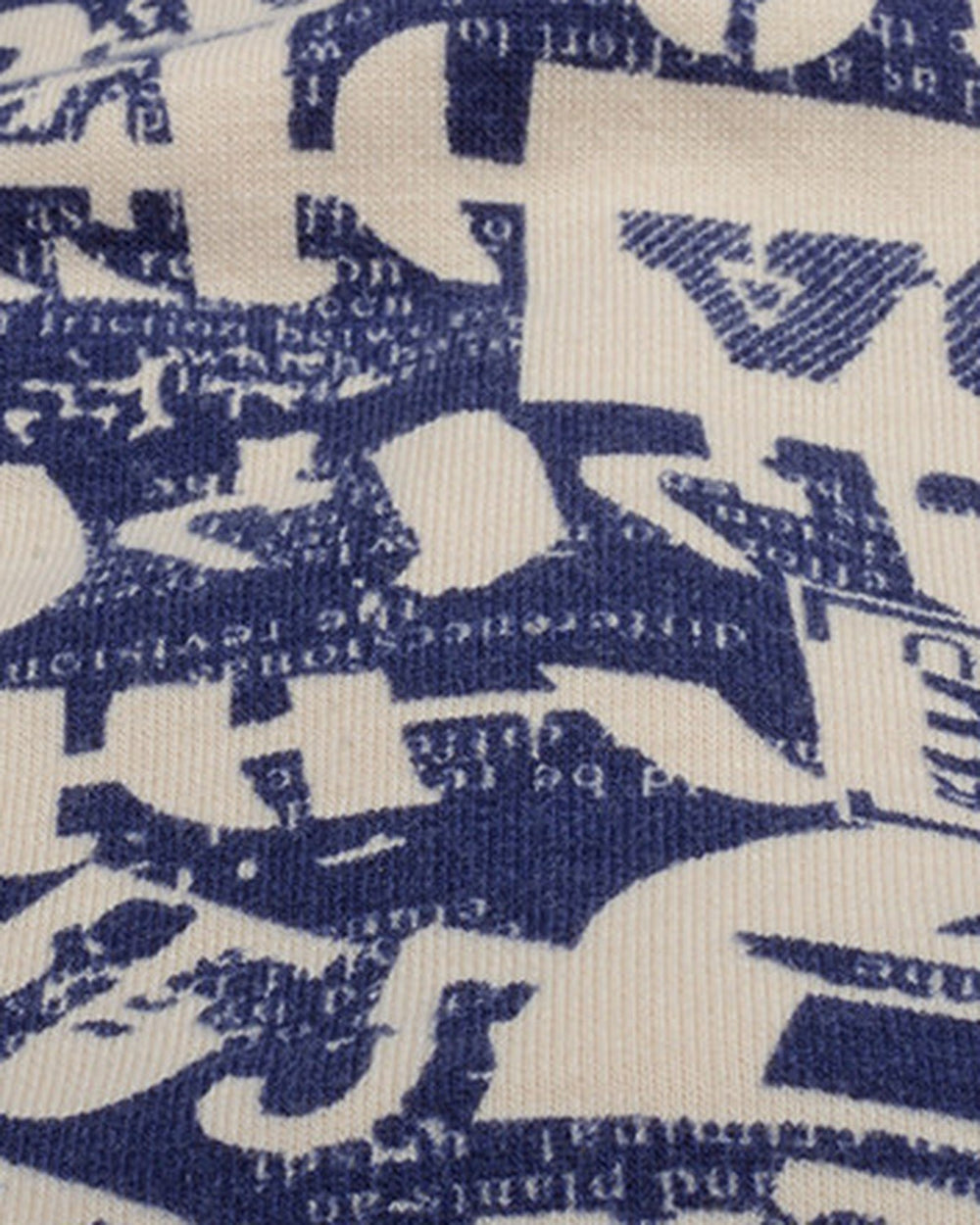 Close-up of the cream newsprint letter print on navy jersey