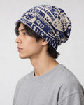 Model wearing the navy letter print beanie, side view showing the slouch