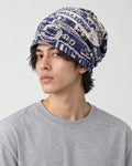 Model wearing the navy letter print beanie, three-quarter view