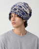 Model wearing the navy letter print beanie, three-quarter view