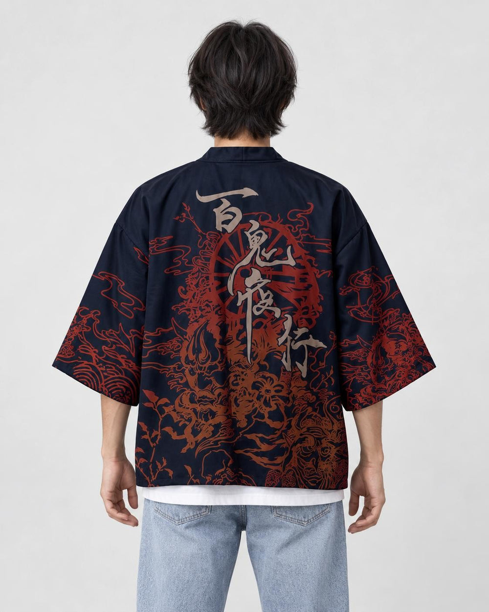 Man seen from behind in the dark navy haori with gray brush characters and red-brown demon drawings on the back