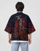 Man seen from behind in the dark navy haori with gray brush characters and red-brown demon drawings on the back