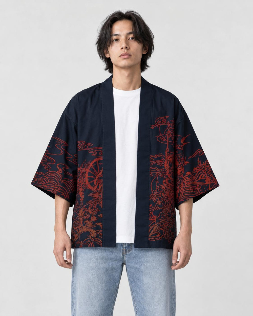 Man in the open dark navy haori with red-brown ink scenes on the front panels, a white tee and light jeans