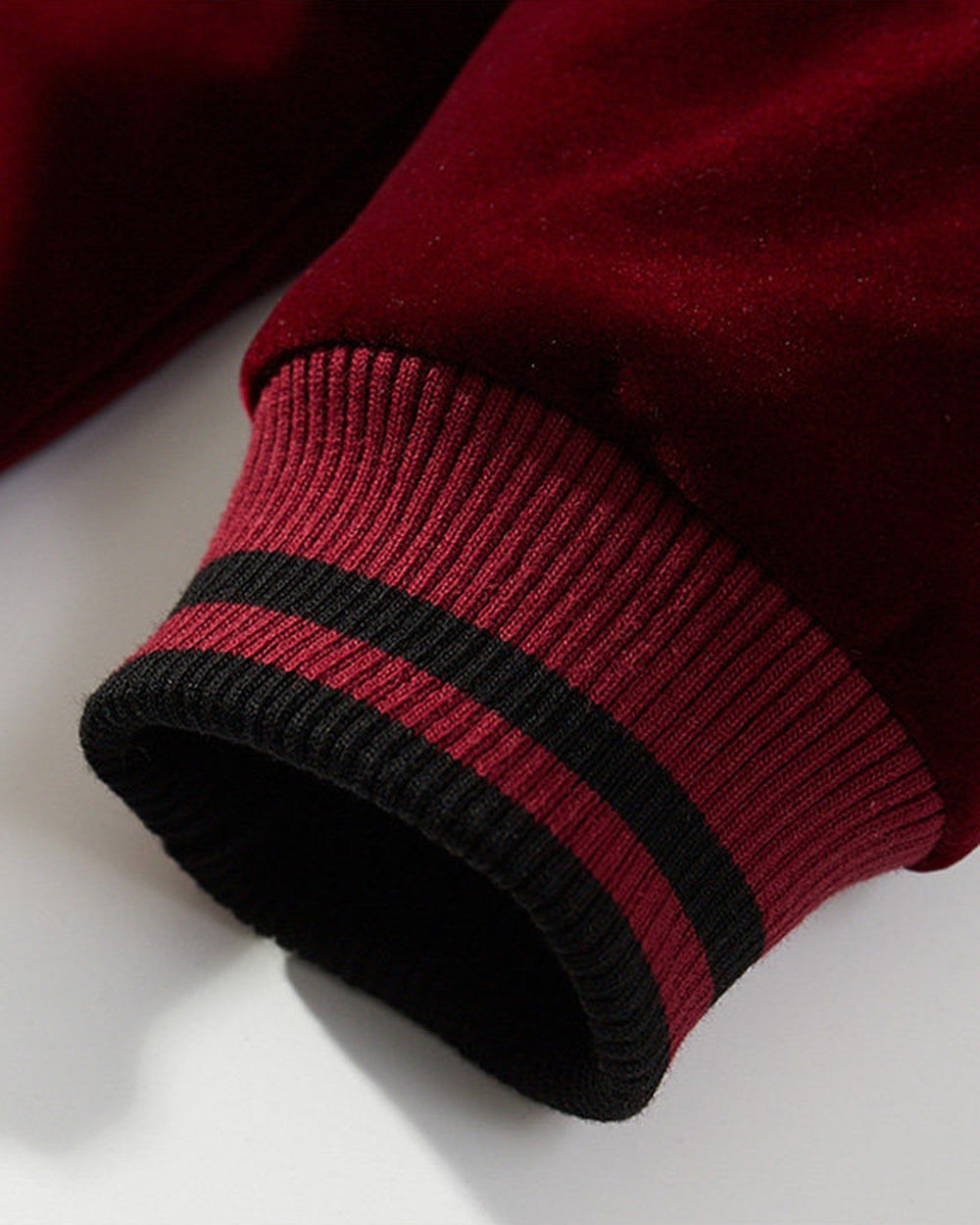 Close-up of the striped rib cuff on the wine red sukajan